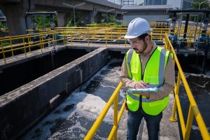 man at water treatment plant looking at water