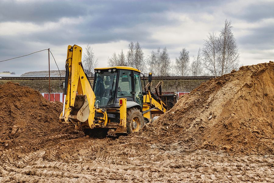Soil Testing - Backhoe moving dirt to be tested