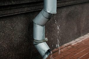 Storm Water Testing pipe on wall with water running out