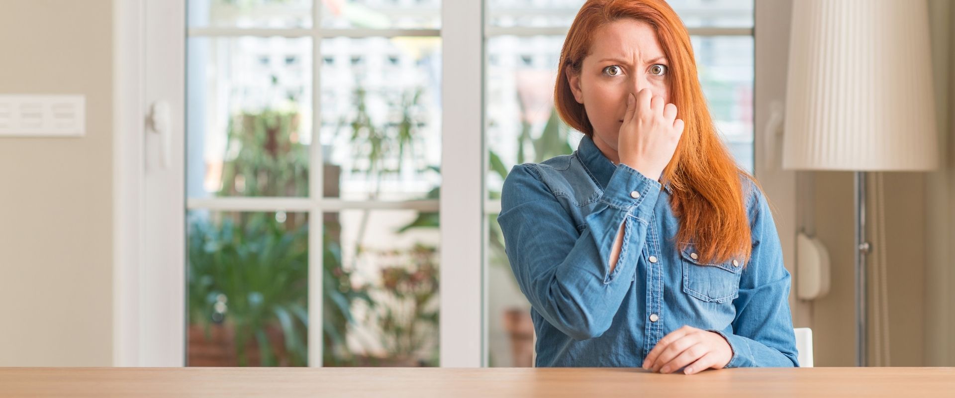 Woman covering her nose due to bad smell