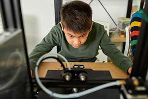 Boy Using 3D Printer