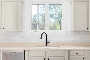 kitchen with white cabinets and a black faucet