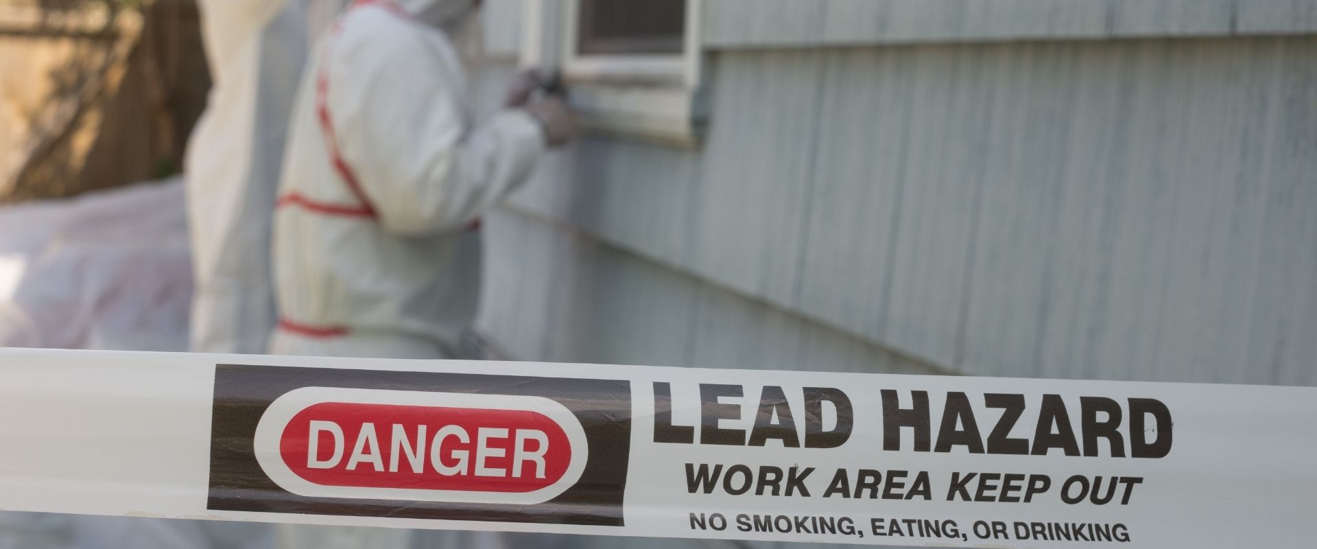 A work area enclosure with the label "Danger, Lead Hazard, Work Area Keep Out"