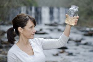 Common Myths About Water Quality Testing Debunked 1 An expert looking at a water sample they just took to test