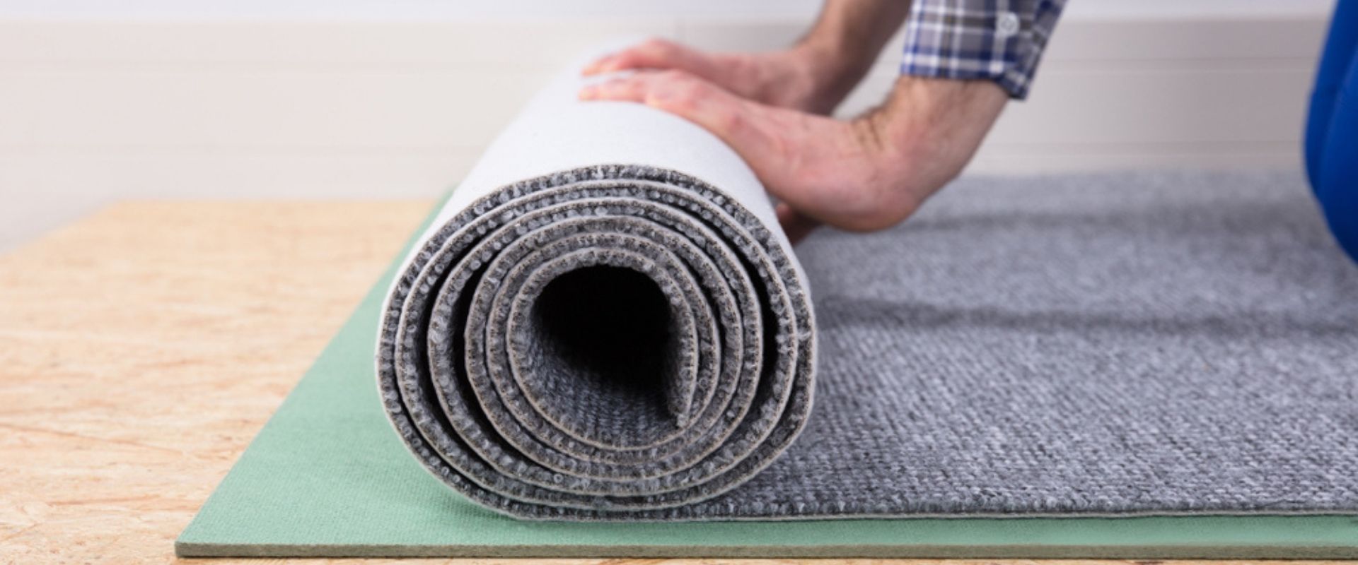 A man rolling out a new carpet