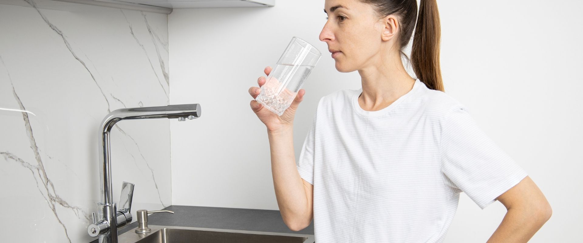 Woman drinking water at risk of saltwater intrusion contamination